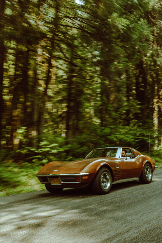 oregon bride and groom posing with a vintage car for their adventure elopement 