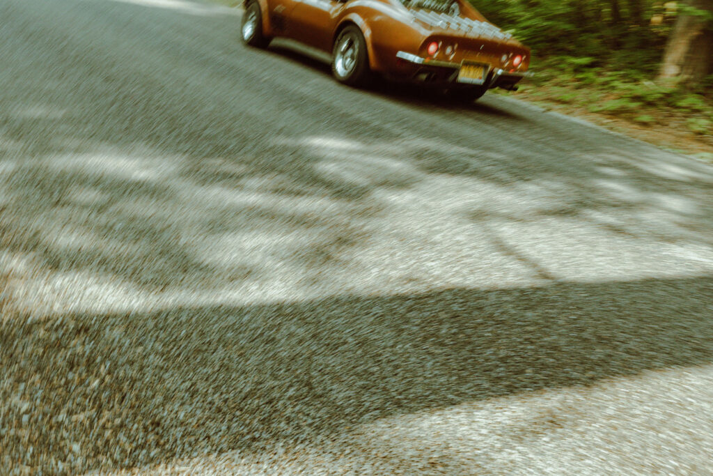 bride and groom at their oregon elopement with a vintage car in a forest