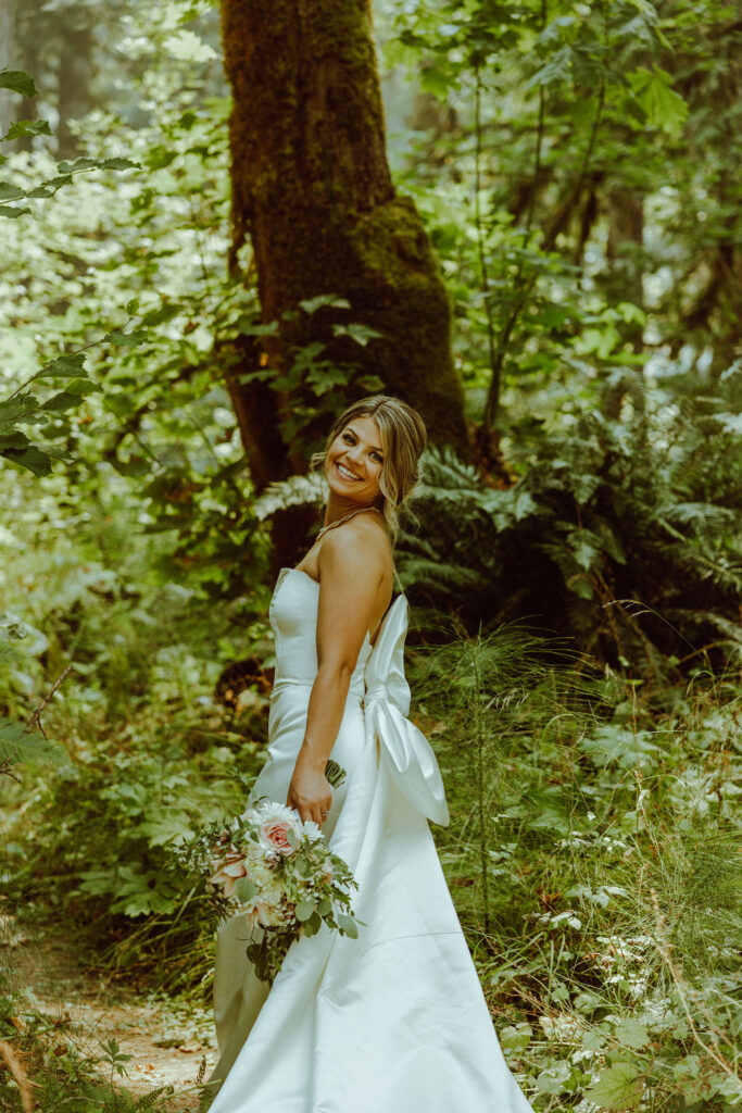 oregon bride posing in oregon forest 