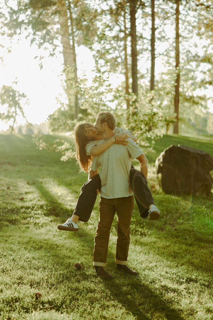 engaged couple poses piggy back for cinematic photoshoot