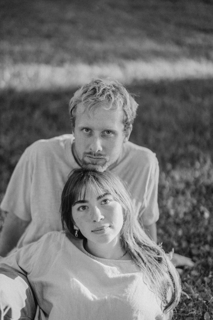 engaged couple poses softly for camera
