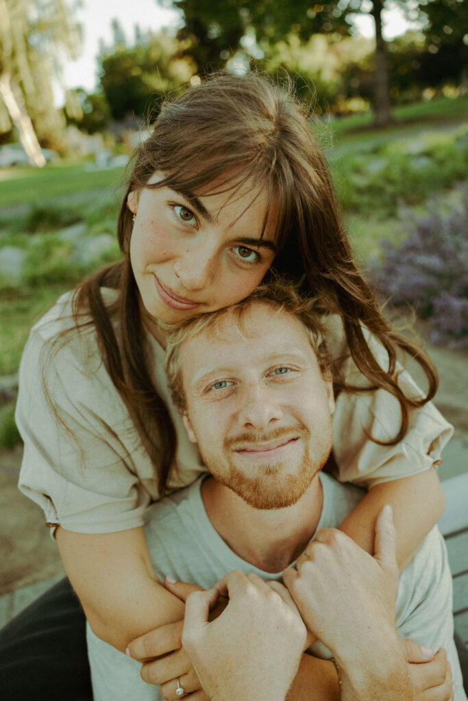 engaged couple poses softly for camera