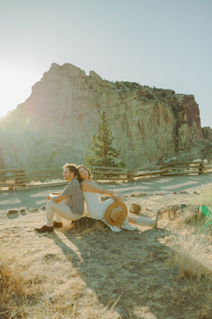 couple sitting at smith rock for engagement session