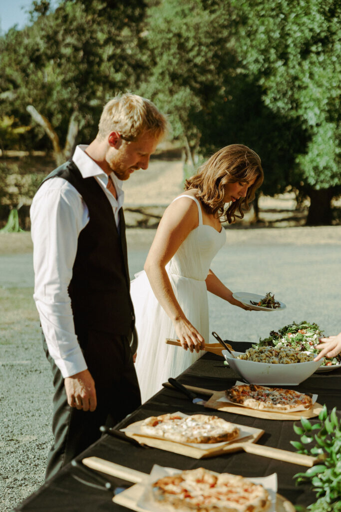 bride and groom going through buffet at wedding reception