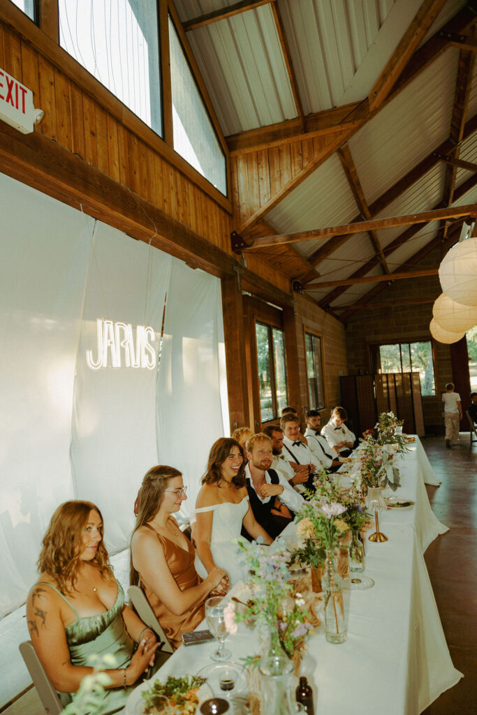 bridal table laughing at toasts 